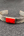 Bracelet artisanal Nuristan Afghanistan, pierre ovale rouge-orangé sur bande striée argent allemand