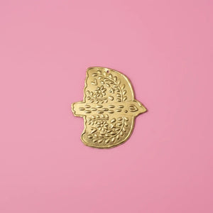KIFF KIFF Amal gold hammered metal dove ex-voto wall ornament with floral engravings on a pink background