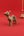 KIFF KIFF brass dromedary camel statuette with intricate wire-wrapped texture on a vibrant red background