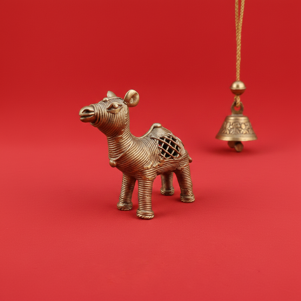 KIFF KIFF brass dromedary camel statuette with intricate wire-wrapped texture on a vibrant red background