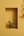 KIFF KIFF handcrafted brass Dhokra parrot statue in a yellow wall niche with a red hibiscus flower
