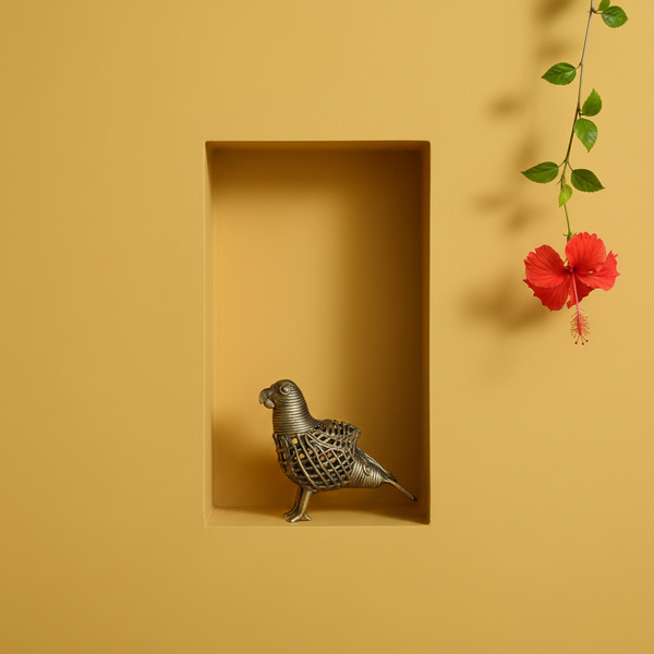 KIFF KIFF handcrafted brass Dhokra parrot statue in a yellow wall niche with a red hibiscus flower