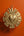 Ex-voto mural KIFF KIFF modèle Ray en métal doré avec cœur central bombé et motifs géométriques sur fond orange