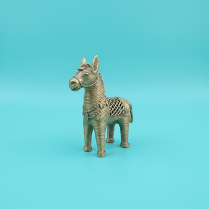 KIFF KIFF gold-toned metal horse statuette with intricate wire-wrapped texture on a solid turquoise background