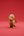 KIFF KIFF gold-toned metal owl statuette with intricate engraved patterns on a solid red background