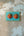 Patère murale artisanale KIFF KIFF en bois bleu avec deux masques de couple hindou peints à la main et 5 crochets.