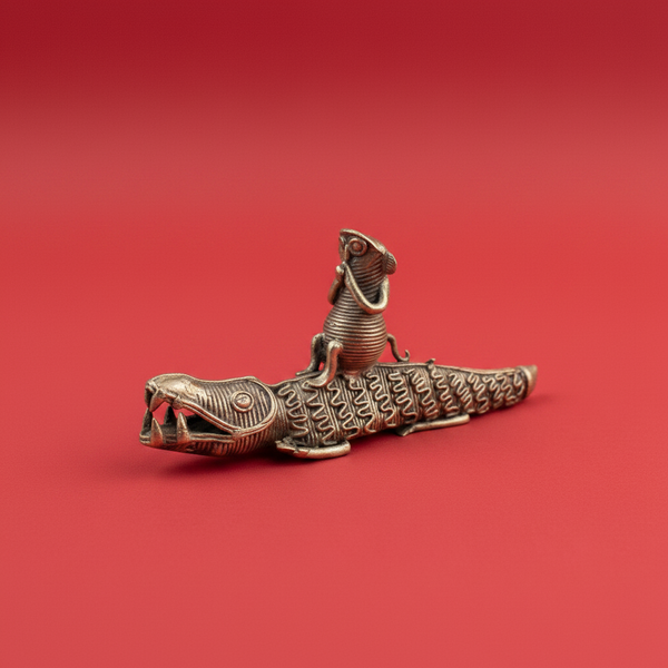 Statuette crocodile KIFF KIFF en métal doré avec un petit personnage assis sur son dos sur fond rouge