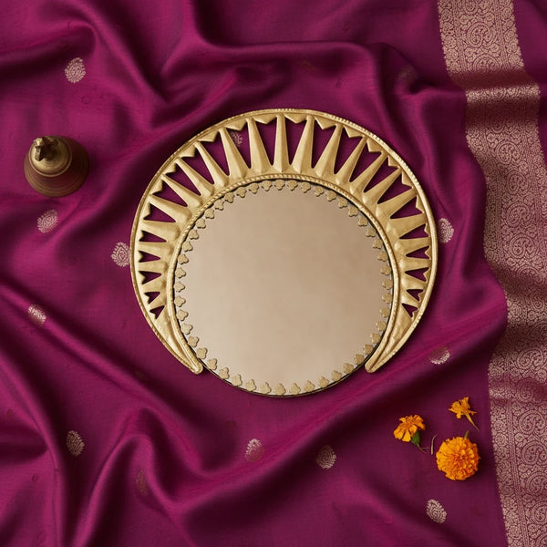 KIFF KIFF Zoya circular mirror with a decorative gold metal frame, displayed on a purple fabric background.